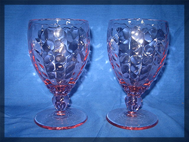 Pair of glass wine goblets in pink
