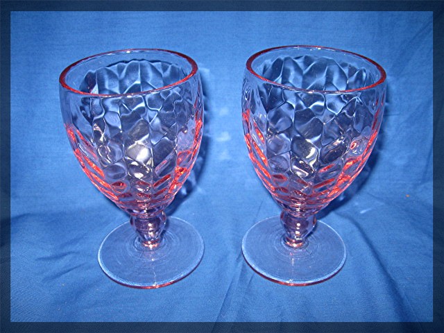 Pair of glass wine goblets in pink