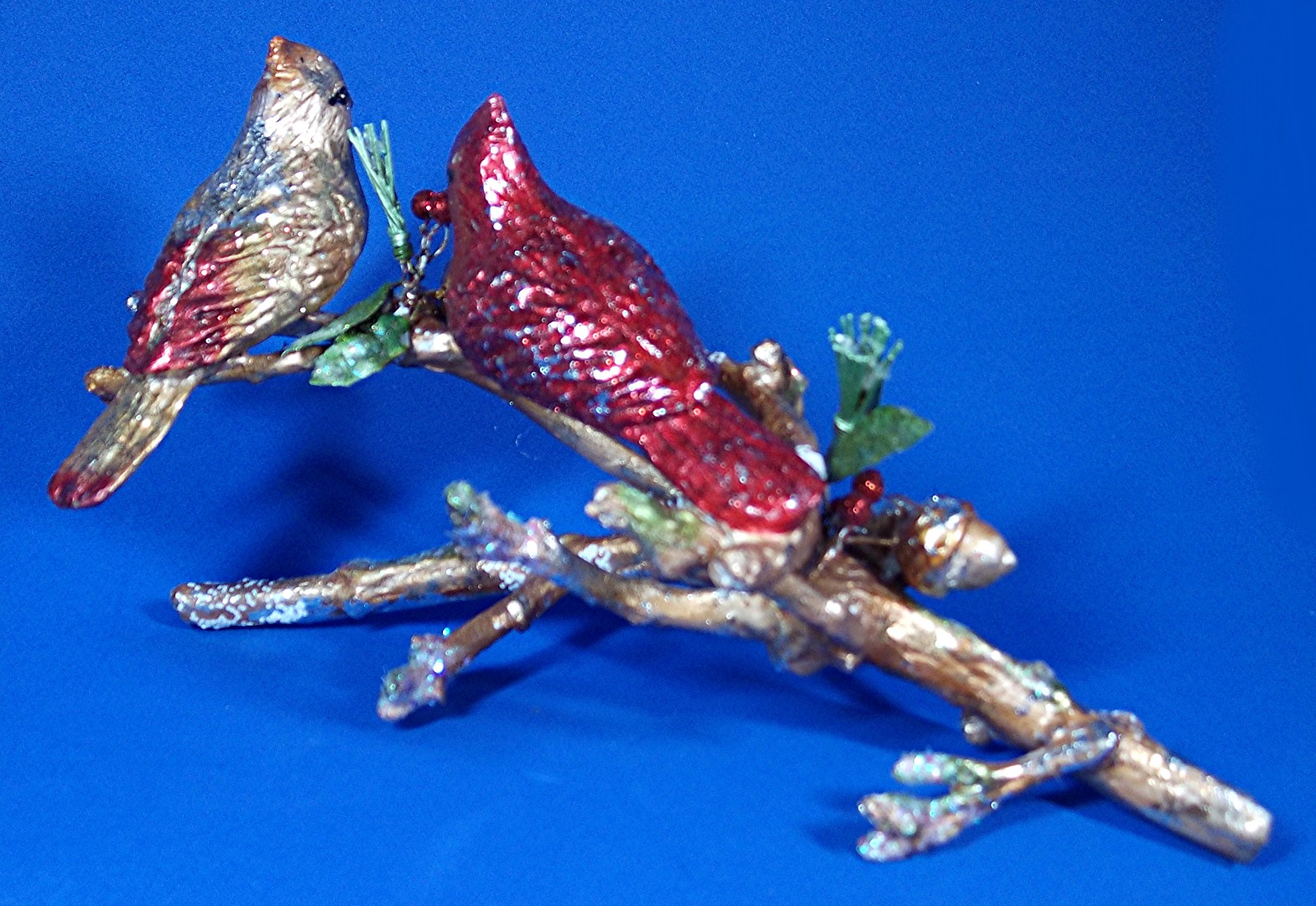 Christmas ornament, cardinal birds on an oak limb
