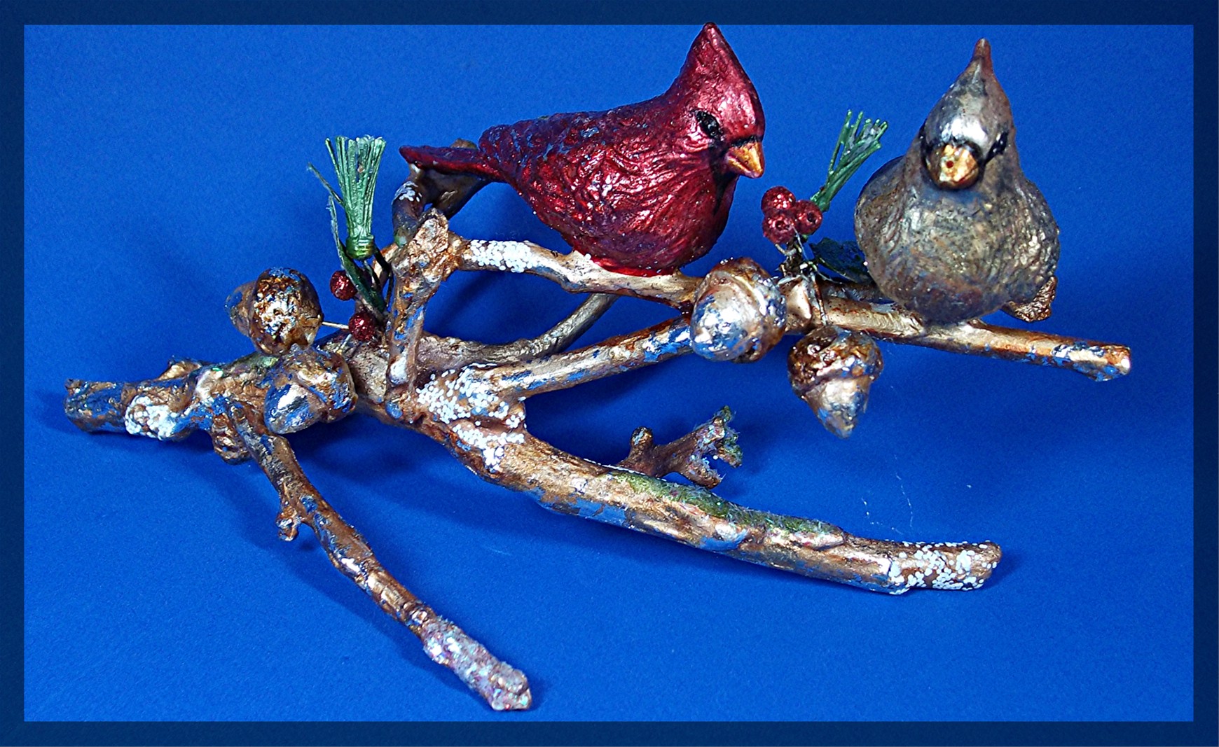 Christmas ornament, cardinal birds on an oak limb